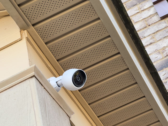 Exterior UniFi Protect surveillance camera under a soffit